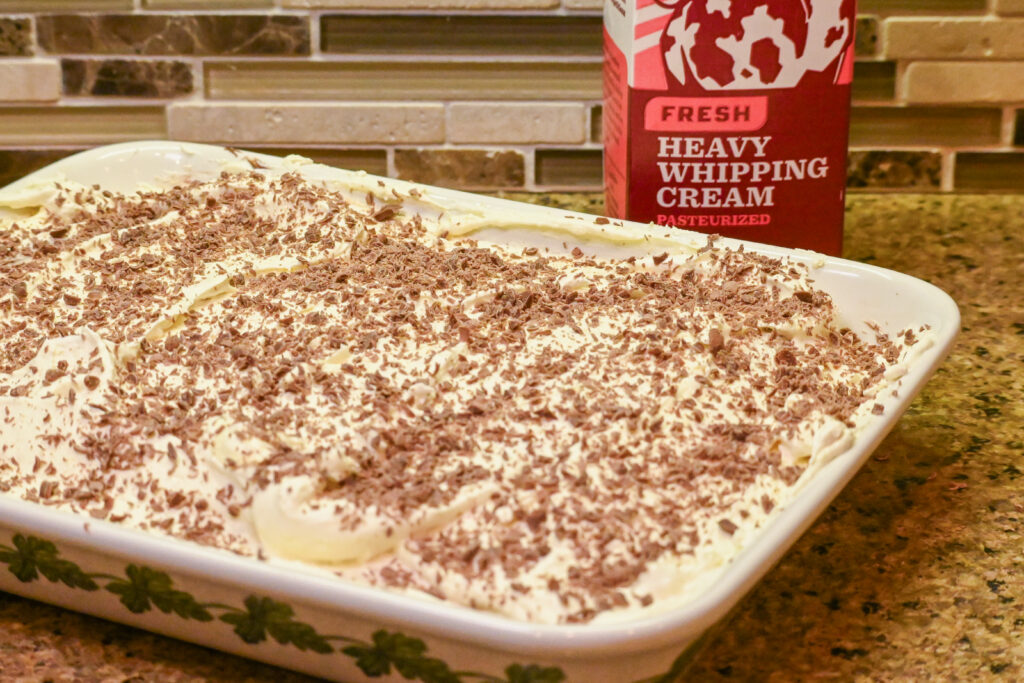 Chocolate Pudding dessert on a kitchen counter with a carton of Heavy Whipping Cream in the background.